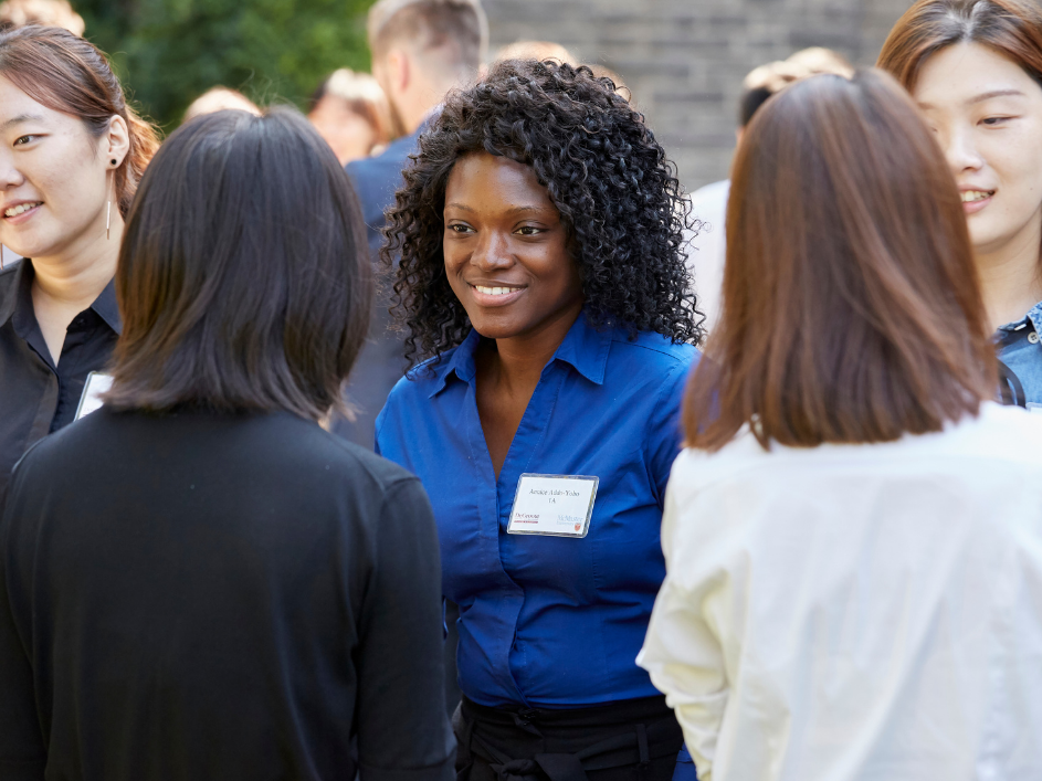 A student in a discussing with a smiling advisor.