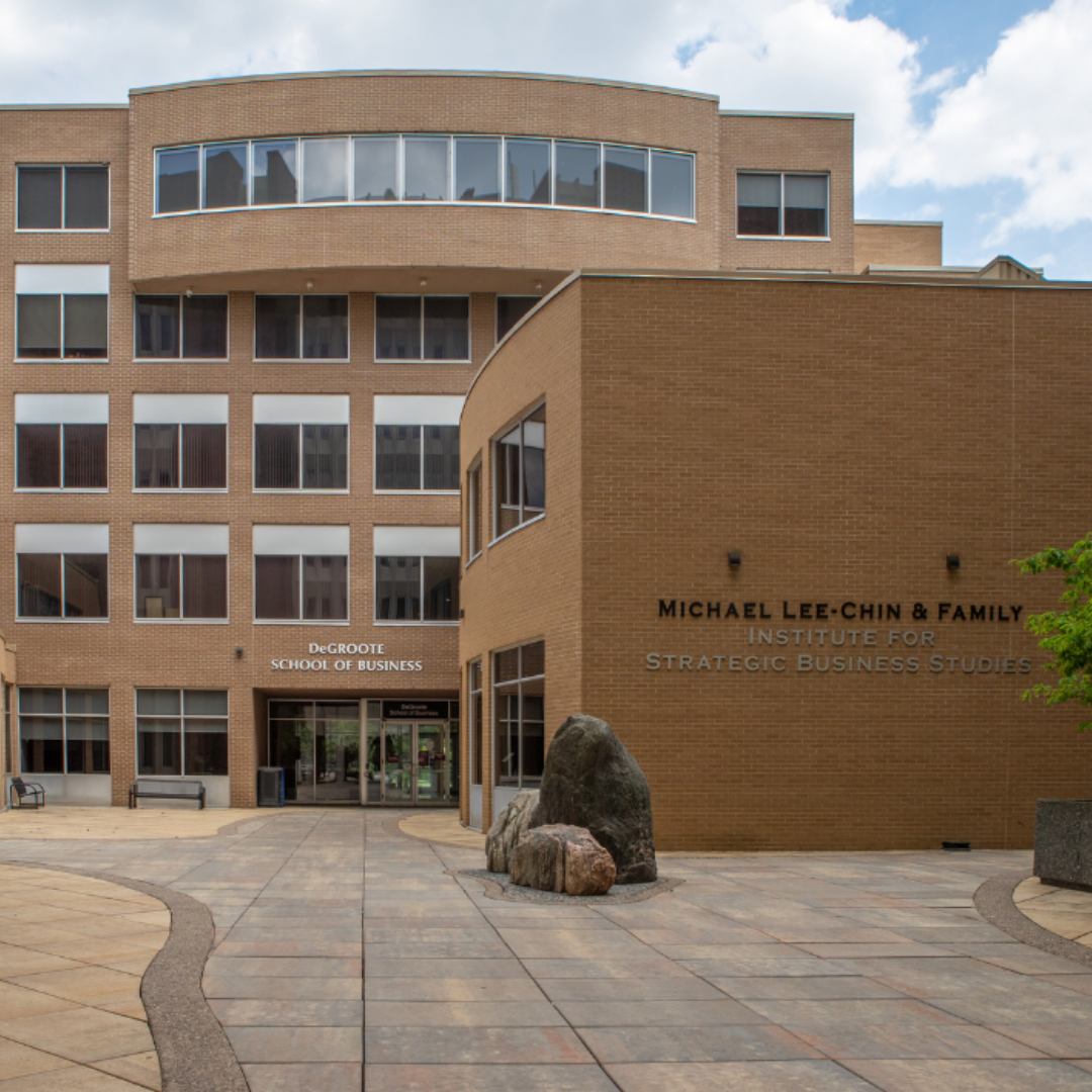 The DeGroote School of Business building, a multi-story brick building, at McMaster University.