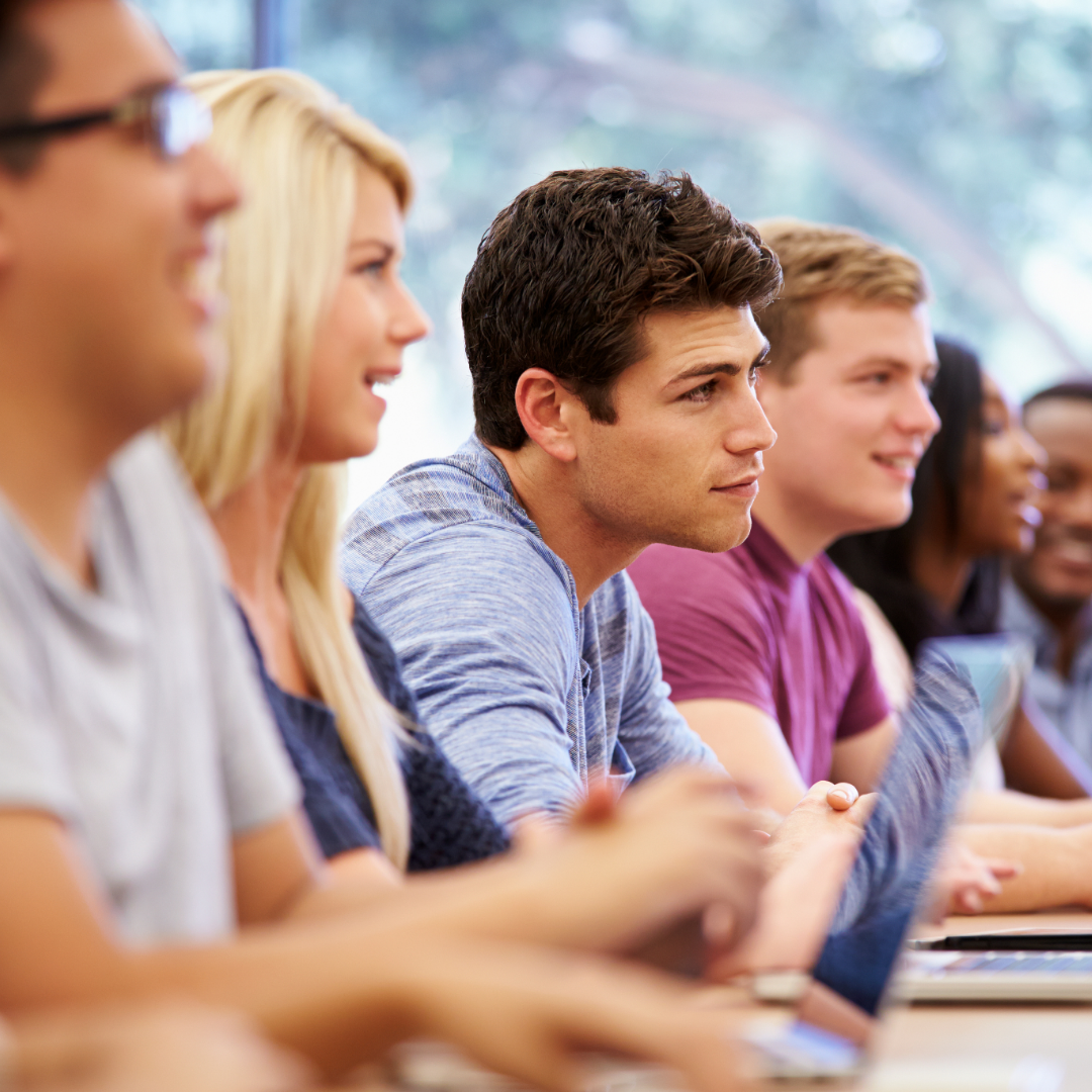A row of seated students listening attentively.